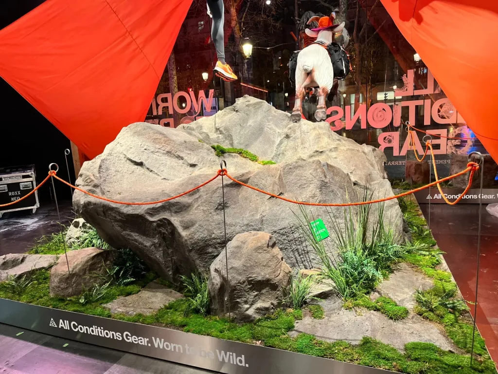 Rock arrangement beside a Paris shop window with a red tent in the background